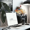 Modern Desk with a Laptop and Minimalistic Decorations